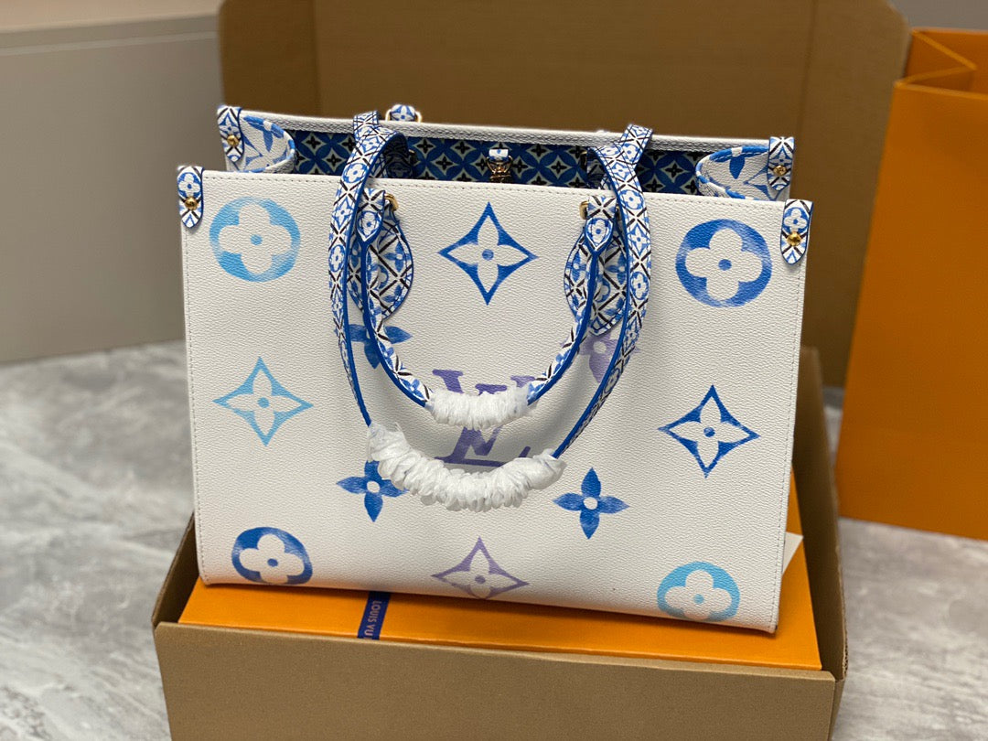 Louis Vuitton Onthego Handbags In White With Blue Embossed