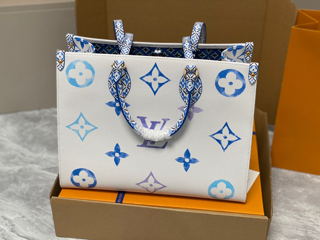 Louis Vuitton Onthego Handbags In White With Blue Embossed