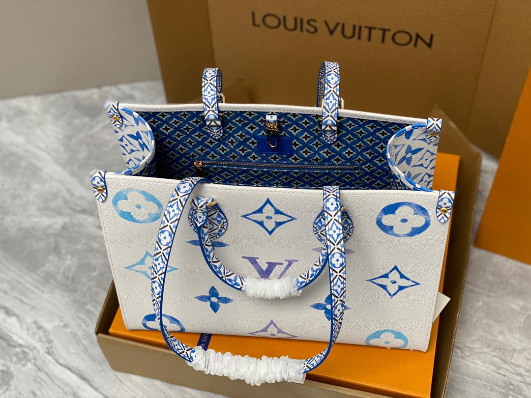 Louis Vuitton Onthego Handbags In White With Blue Embossed