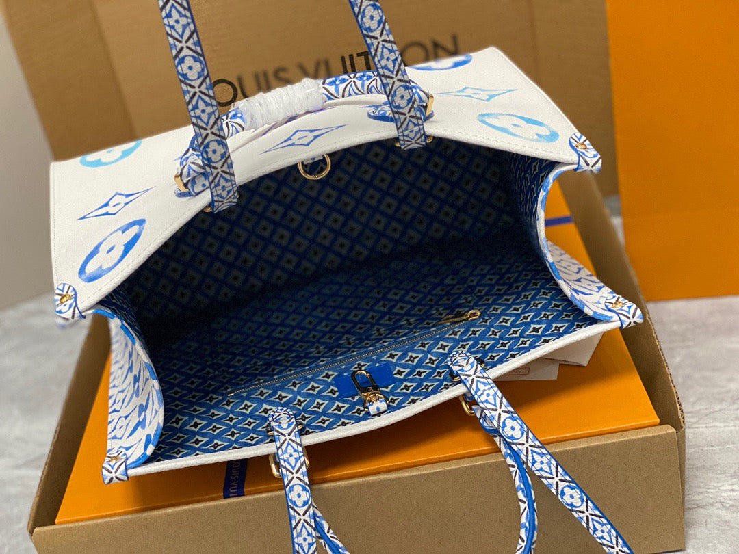 Louis Vuitton Onthego Handbags In White With Blue Embossed