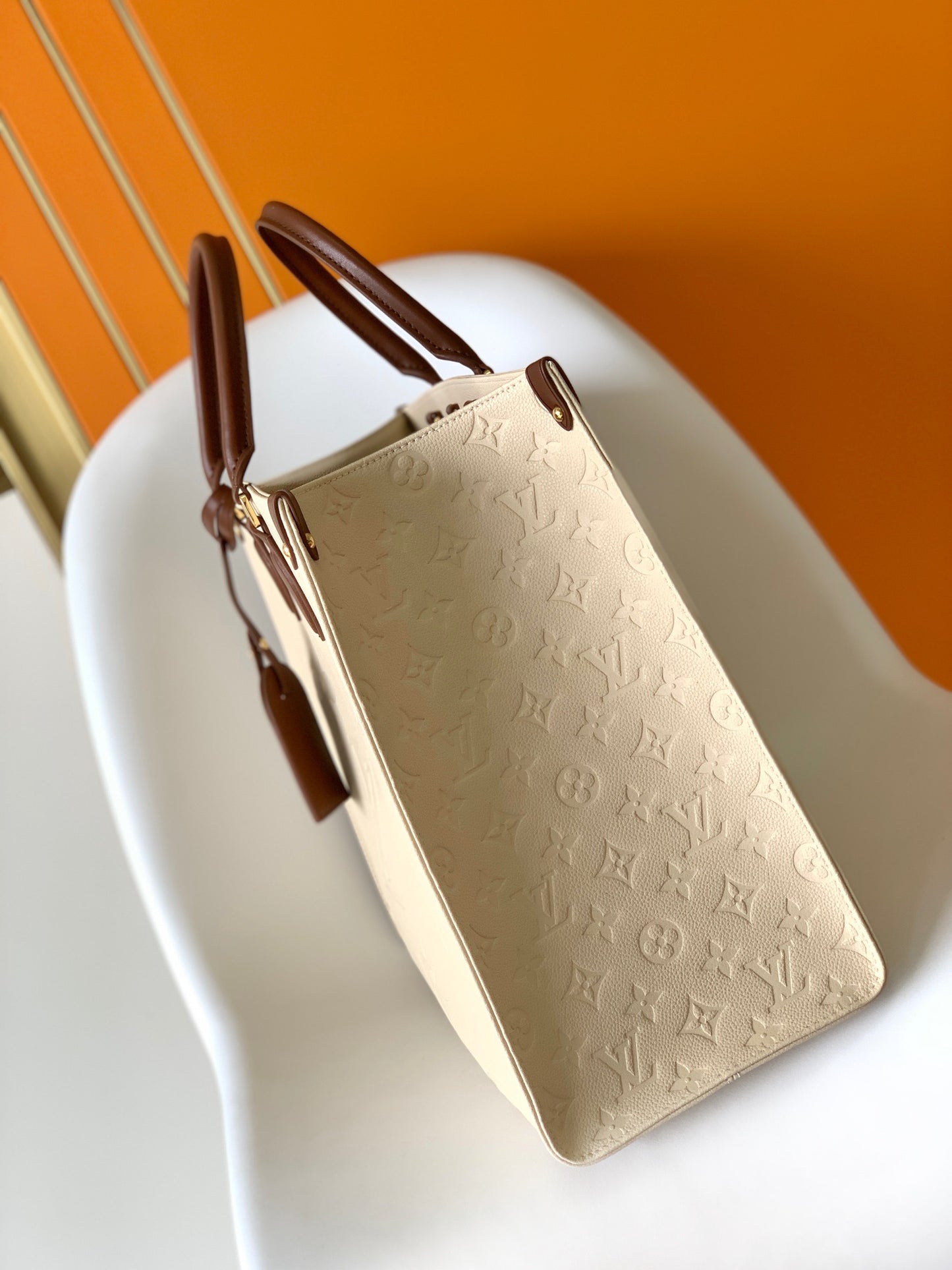 Louis Vuitton Onthego Handbags In Beige Embossed With Caramel Handle