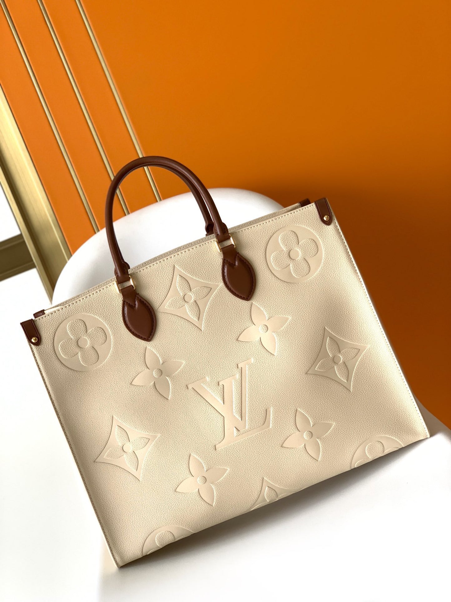 Louis Vuitton Onthego Handbags In Beige Embossed With Caramel Handle