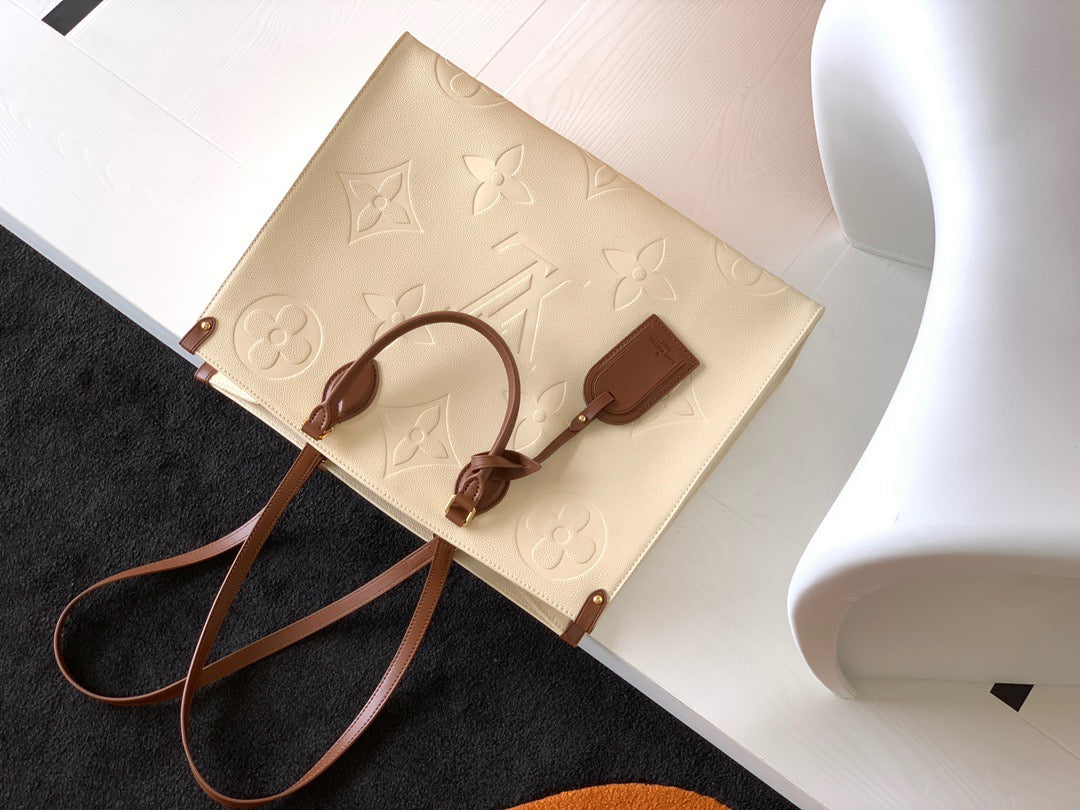 Louis Vuitton Onthego Handbags In Beige Embossed With Caramel Handle